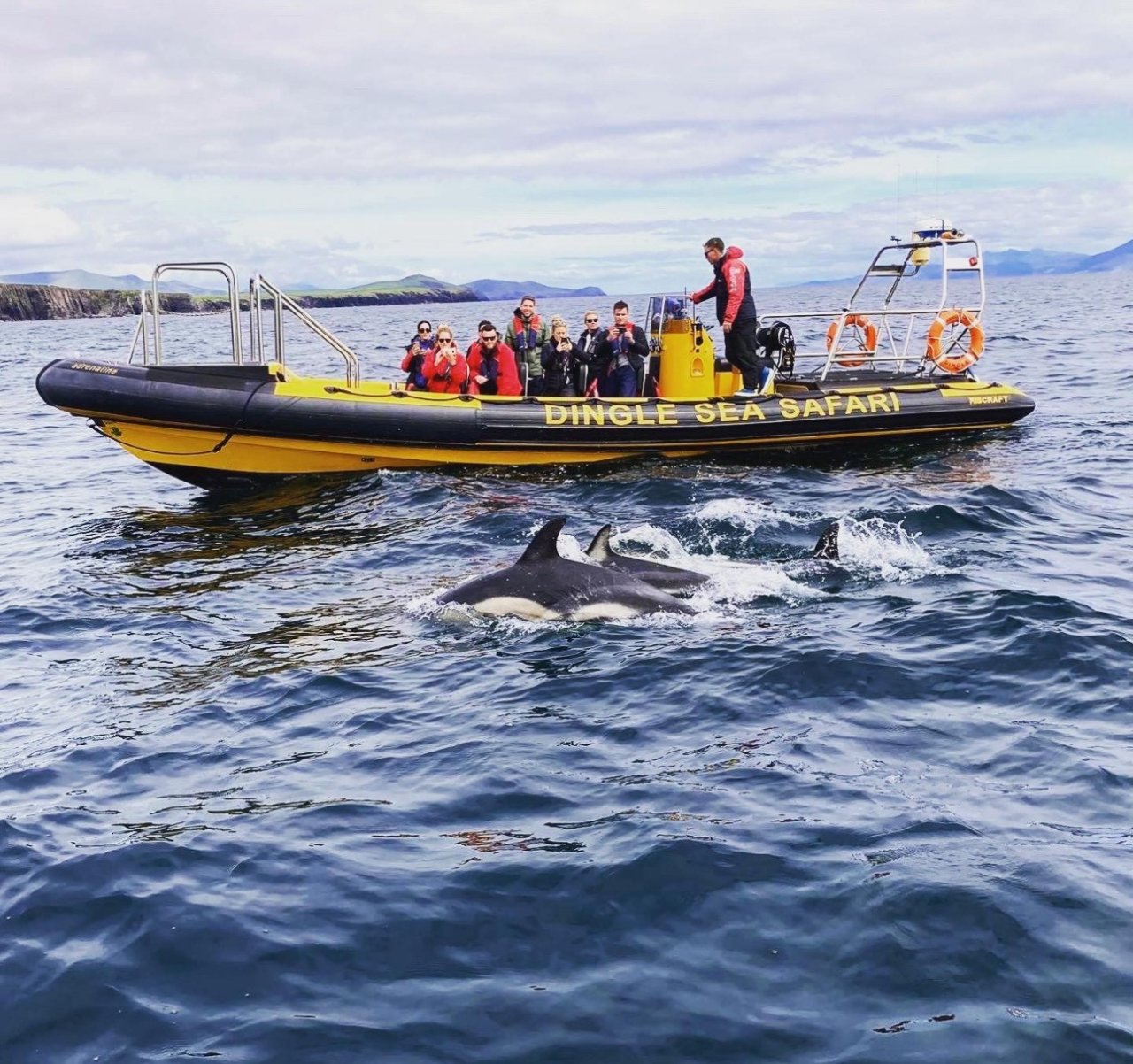 people on yellow rib on water 